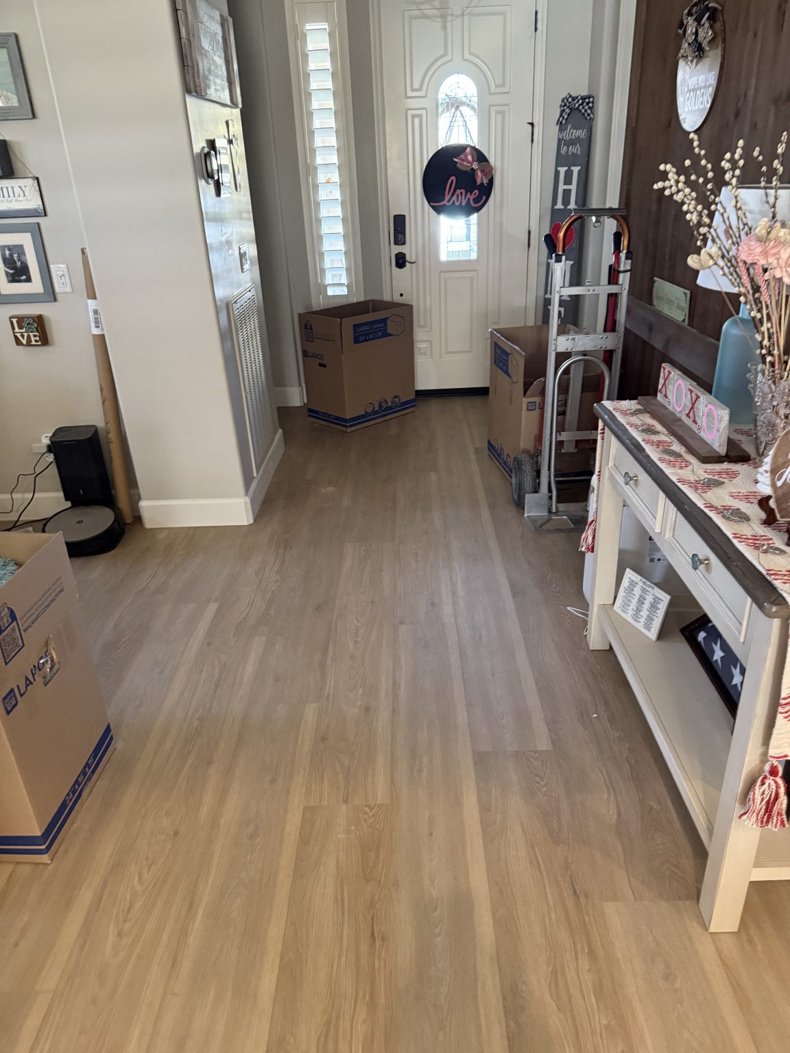 Entryway after — new wide-plank hardwood